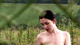 Sitting in the middle of the field and teasing her hole